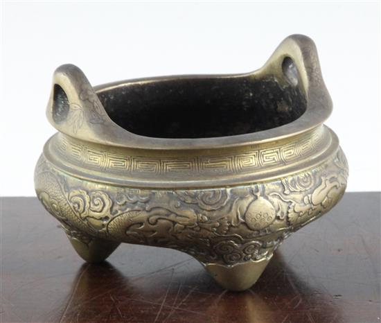 A Chinese bronze dragon tripod censer, 19th century, 14cm across